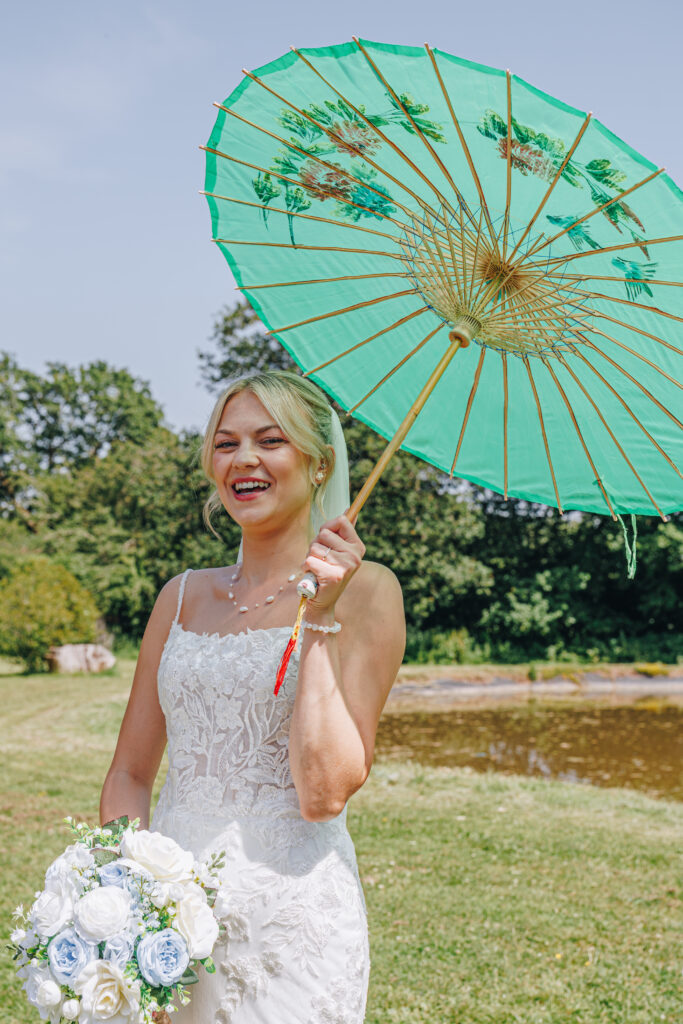 Bride holding an umbrella at the limes country lodge hotel photographed by georgia anne photography